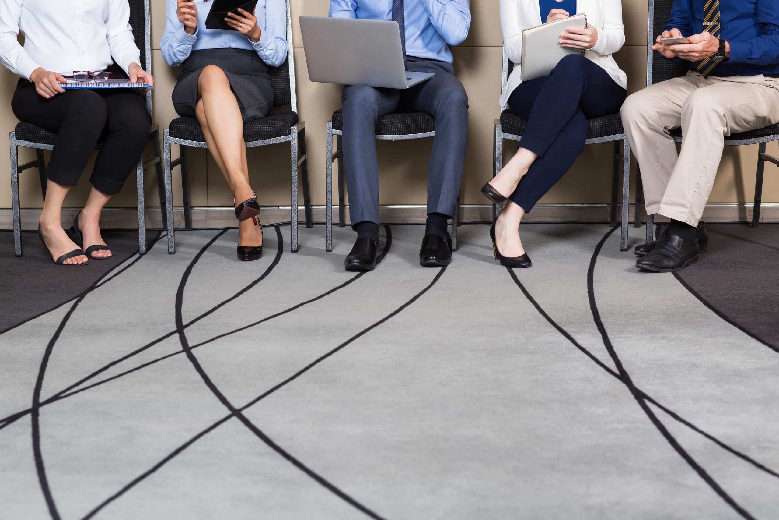 Cropped View of Business People Sitting in Row
